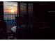 Sunset view from dining table overlooking the beach with tranquil water and beach front property at 6700 Gulf Dr # B8, Holmes Beach, FL 34217