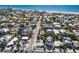 Aerial view of a charming coastal community with a beach, and white home near the ocean at 701 N Bay Blvd, Anna Maria, FL 34216