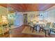 Charming dining area with wooden floors, beach decor, and seating near large windows at 701 N Bay Blvd, Anna Maria, FL 34216