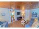 Inviting living room with TV, comfortable seating, and stylish decor at 701 N Bay Blvd, Anna Maria, FL 34216