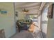 Relaxing covered patio with comfortable seating and ceiling fan at 701 N Bay Blvd, Anna Maria, FL 34216