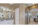 A bathroom with a vanity and an arched doorway to the main bedroom at 7017 Lennox Pl, University Park, FL 34201