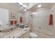 Bathroom featuring granite countertops, tile shower, bathtub, and neutral tones at 7017 Lennox Pl, University Park, FL 34201