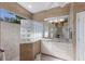 A well-lit bathroom features a vanity and glass block shower at 7017 Lennox Pl, University Park, FL 34201