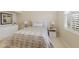 Inviting bedroom with plush bedding, white furniture, plantation shutters, and relaxing decor at 7017 Lennox Pl, University Park, FL 34201