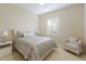 Serene bedroom featuring a comfortable bed, soft lighting, and a bright window with plantation shutters at 7017 Lennox Pl, University Park, FL 34201