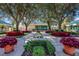 Beautifully landscaped clubhouse featuring mature trees, vibrant flowerbeds, and a welcoming entrance at 7017 Lennox Pl, University Park, FL 34201