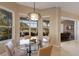 Bright dining area with large windows overlooking a patio, and a stylish chandelier at 7017 Lennox Pl, University Park, FL 34201
