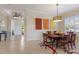 Open dining room with tile flooring, transom window, and modern light fixture at 7017 Lennox Pl, University Park, FL 34201