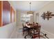 Elegant dining room with modern lighting, stylish artwork, and a bright, inviting atmosphere at 7017 Lennox Pl, University Park, FL 34201