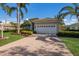 Beautiful home featuring a tile roof, mature palm trees, and a well-manicured lawn at 7017 Lennox Pl, University Park, FL 34201