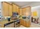 Well-lit kitchen with stainless steel appliances, tile backsplash, and wooden cabinets at 7017 Lennox Pl, University Park, FL 34201