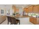 Well-lit kitchen with granite countertops, stainless steel appliances, and bar seating at 7017 Lennox Pl, University Park, FL 34201