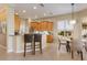 Open kitchen area with counter seating, stainless steel appliances, and a cozy breakfast nook at 7017 Lennox Pl, University Park, FL 34201