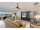 Spacious living room with comfortable leather sofas, entertainment center, and beautiful water views at 7017 Lennox Pl, University Park, FL 34201