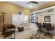 Comfortable living room area with a built-in desk, chair, and window with natural light at 7017 Lennox Pl, University Park, FL 34201