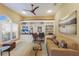 Cozy living room with custom built-ins, comfortable seating, and a well-lit workspace at 7017 Lennox Pl, University Park, FL 34201