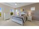 A bright main bedroom with large windows, a ceiling fan and neutral decor at 7017 Lennox Pl, University Park, FL 34201