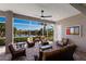 Screened lanai with comfortable seating offering serene lake views and outdoor relaxation at 7017 Lennox Pl, University Park, FL 34201