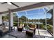 Cozy lanai with comfortable seating and scenic lake views, ideal for enjoying the outdoors at 7017 Lennox Pl, University Park, FL 34201