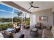 Relaxing screened-in patio with cushioned seating, overlooking a peaceful waterfront view at 7017 Lennox Pl, University Park, FL 34201