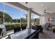 Covered patio with outdoor dining and waterfront views, perfect for entertaining or relaxing at 7017 Lennox Pl, University Park, FL 34201