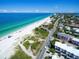Stunning aerial view featuring a beautiful sandy beach, ocean views, and charming beachfront homes at 8403 Grand Estuary Trl # 103, Bradenton, FL 34212