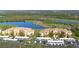 Scenic view of a beautiful community with manicured golf course, serene lake, and attractive condominium buildings at 8403 Grand Estuary Trl # 103, Bradenton, FL 34212