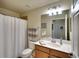 Bathroom featuring a white sink vanity, mirror, and a shower with a white curtain at 8403 Grand Estuary Trl # 103, Bradenton, FL 34212