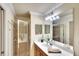 Bathroom featuring a white sink vanity and a glass-enclosed walk-in shower at 8403 Grand Estuary Trl # 103, Bradenton, FL 34212