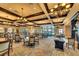Spacious dining area with elegant chandeliers, comfortable seating, and large windows offering ample natural light at 8403 Grand Estuary Trl # 103, Bradenton, FL 34212
