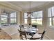 Cozy breakfast nook featuring a round table, four chairs and natural light from the three surrounding windows at 8403 Grand Estuary Trl # 103, Bradenton, FL 34212