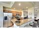 Modern kitchen with granite countertops, stainless steel appliances, and breakfast bar seating at 8403 Grand Estuary Trl # 103, Bradenton, FL 34212