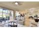 Open-concept living room with screened patio and modern kitchen at 8403 Grand Estuary Trl # 103, Bradenton, FL 34212