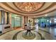 Beautiful lobby with a stunning chandelier, elegant columns, and a calming water feature at 8403 Grand Estuary Trl # 103, Bradenton, FL 34212