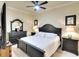 Bedroom with dark furniture set, white bedding, ceiling fan and serene ambiance at 8403 Grand Estuary Trl # 103, Bradenton, FL 34212