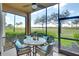 Screened lanai featuring comfortable seating and scenic views of the surrounding greenery and lake at 8403 Grand Estuary Trl # 103, Bradenton, FL 34212