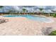 Resort-style pool with a spacious pool deck, lounge chairs, and palm trees at 8403 Grand Estuary Trl # 103, Bradenton, FL 34212