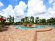 A luxurious community pool features lounge chairs and beautifully landscaped plants at 8403 Grand Estuary Trl # 103, Bradenton, FL 34212