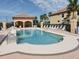 Community pool area offers a cabana and plenty of lounge seating for relaxation at 8403 Grand Estuary Trl # 103, Bradenton, FL 34212