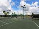 Well-maintained tennis courts with lush surroundings and lighting for evening play at 8403 Grand Estuary Trl # 103, Bradenton, FL 34212