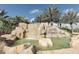 Stunning waterfall feature with 'River Strand' signage, surrounded by tropical plants and decorative rocks at 8403 Grand Estuary Trl # 103, Bradenton, FL 34212
