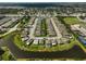 Wide aerial view of the neighborhood featuring community ponds and manicured lawns at 9032 Excelsior Loop, Venice, FL 34293