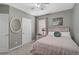 Cozy bedroom featuring neutral walls, white trim, and natural light from the window at 9032 Excelsior Loop, Venice, FL 34293