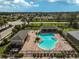 Aerial view of a community pool with a lounging area at 9032 Excelsior Loop, Venice, FL 34293