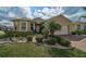 Charming single Gathering home featuring brick driveway and lush tropical landscaping at 9032 Excelsior Loop, Venice, FL 34293