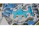 Aerial view of a large pool with lounge chairs and umbrellas, surrounded by beautifully landscaped grounds at 9127 Barrier Coast Trl, Parrish, FL 34219