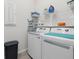 Well-equipped laundry room with modern appliances, shelving for storage, and a functional layout at 9127 Barrier Coast Trl, Parrish, FL 34219