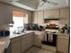 View of the kitchen with tiled flooring, and white cabinets at 96 Broadmoor Ln, Rotonda West, FL 33947