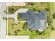 Overhead shot of stunning property featuring lush landscaping, elegant circular driveway, and a screened in pool at 10002 Cherry Hills Avenue Cir, Bradenton, FL 34202